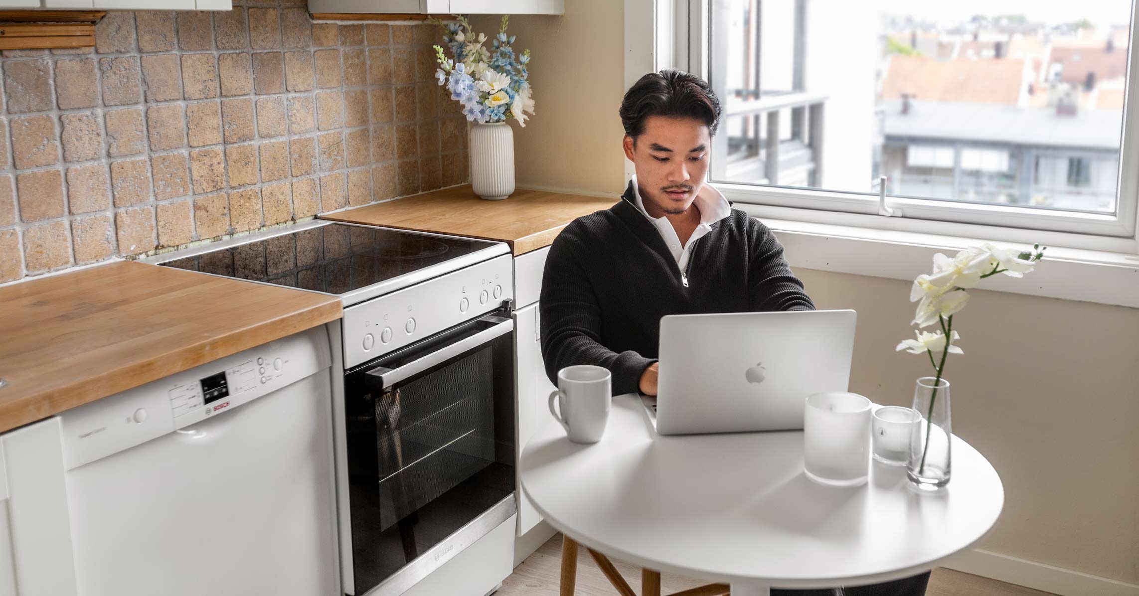 Male online student studying in his kitchen