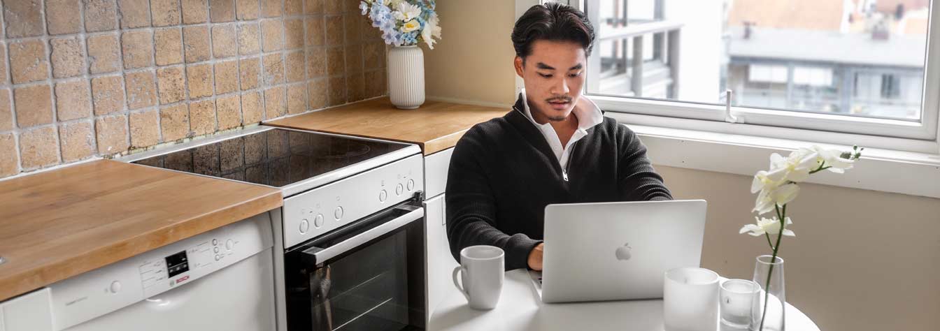Male online student studying in his kitchen